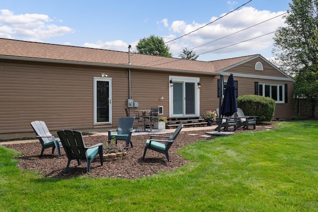 6235 George Fox Dr, Galloway, OH 43119 - back of property with entry steps, a lawn, roof with shingles, and a patio area