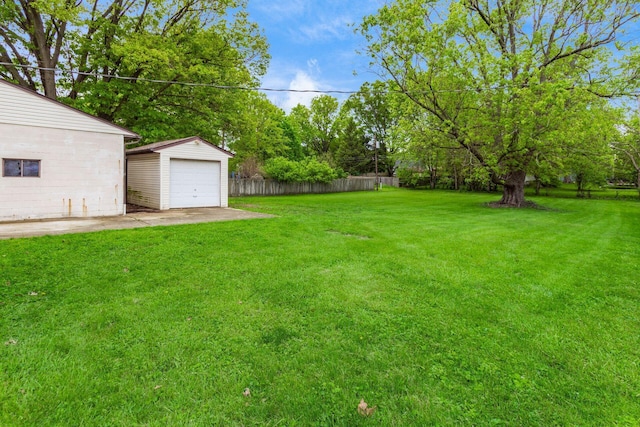 1310 Acton Rd, Columbus, OH 43224 - view of yard with an outdoor structure, view of scattered trees, and a detached garage