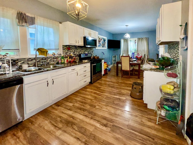 329 S Terrace Ave, Columbus, OH 43204 - kitchen featuring appliances with stainless steel finishes, tasteful backsplash, white cabinetry, and a sink
