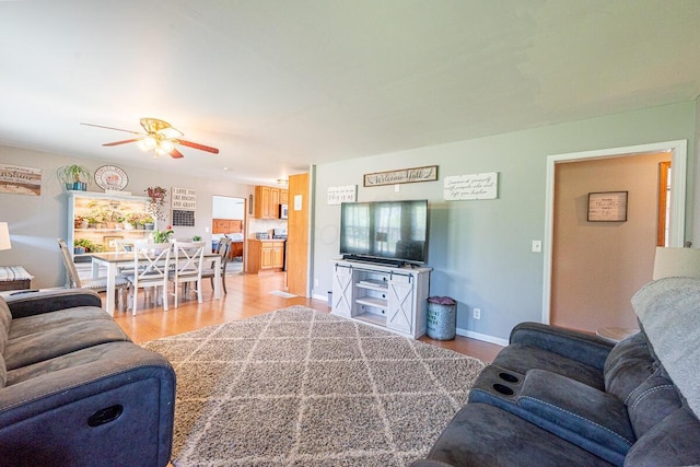 1485 E Choctaw Dr, London, OH 43140 - living area featuring ceiling fan, light wood-style floors, and baseboards