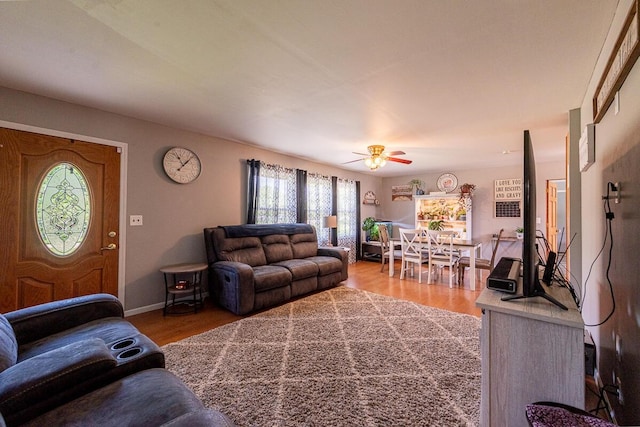 1485 E Choctaw Dr, London, OH 43140 - living area with light wood finished floors, a ceiling fan, and baseboards