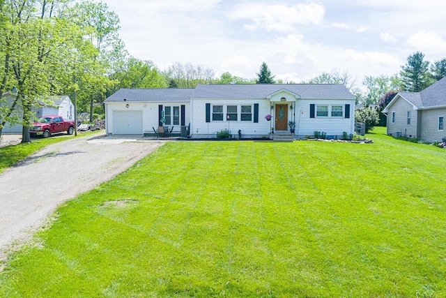 1485 E Choctaw Dr, London, OH 43140 - view of front of home with a garage, dirt driveway, and a front yard