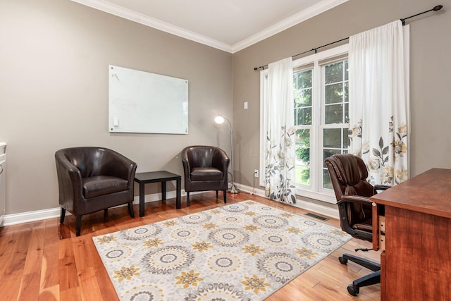 office area with crown molding, healthy amount of natural light, wood finished floors, and baseboards