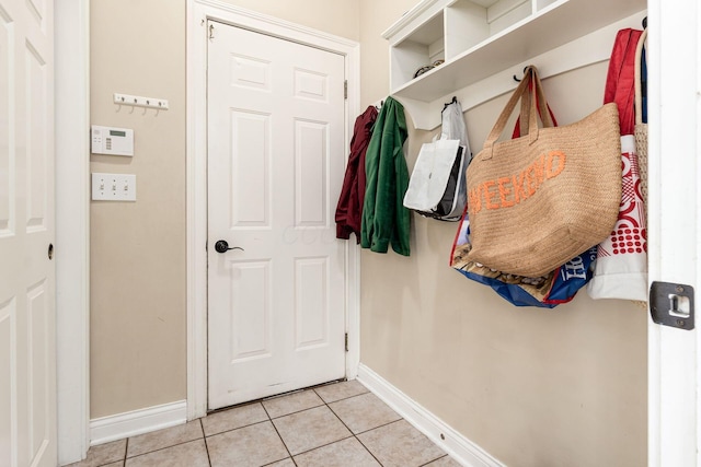 mudroom featuring baseboards and light tile patterned flooring