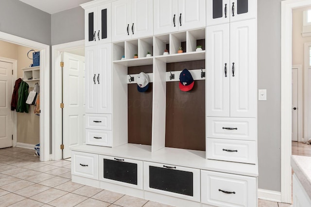 mudroom featuring light tile patterned floors and baseboards