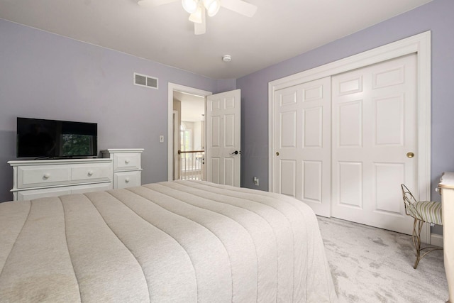 bedroom with light carpet, a closet, and ceiling fan