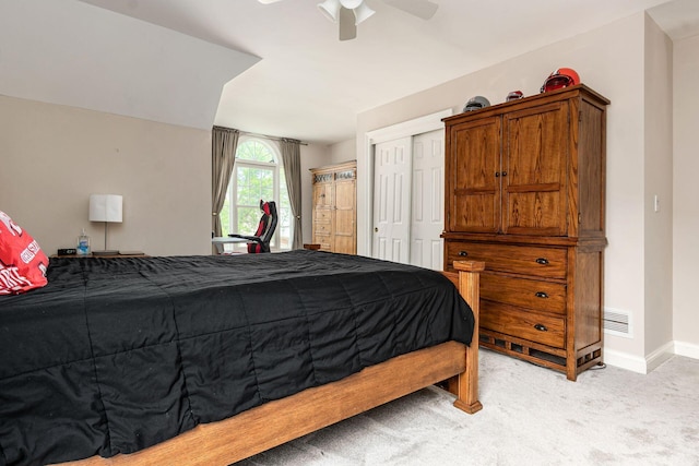 bedroom featuring light carpet, baseboards, a closet, and a ceiling fan