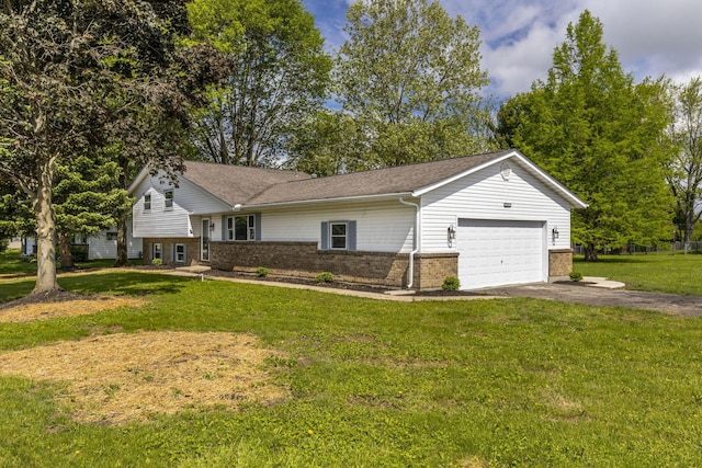 tri-level home with brick siding, a garage, driveway, and a front yard