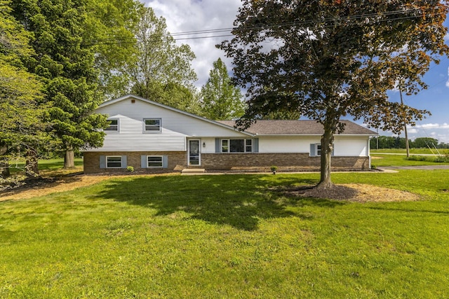 split level home with a front yard and brick siding