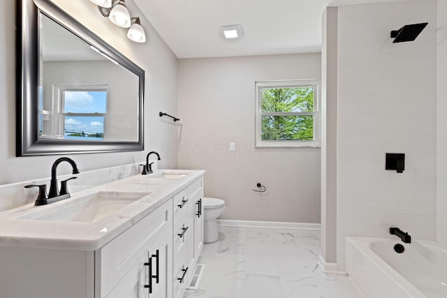 bathroom featuring marble finish flooring, toilet, baseboards, double vanity, and shower / bathtub combination