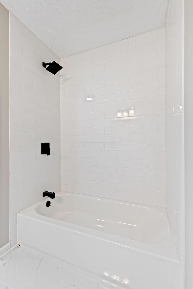 full bath featuring shower / bathtub combination and marble finish floors