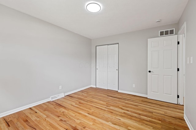 unfurnished bedroom featuring light wood-style flooring and baseboards