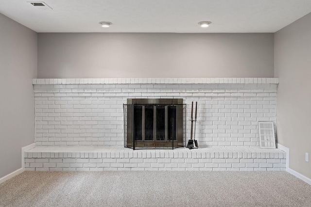 detailed view of carpet flooring, a fireplace, and baseboards