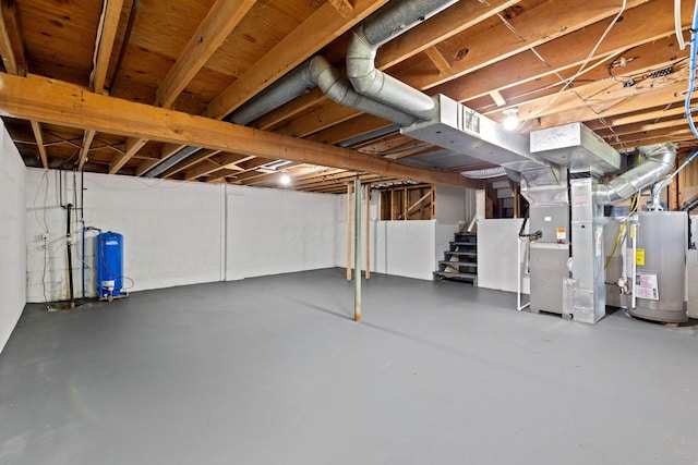 unfinished basement with water heater, stairway, heating unit, and a water pressure tank