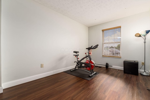 3854 Sugarbark Dr, Canal Winchester, OH 43110 - exercise area featuring wood finished floors, baseboards, and a textured ceiling