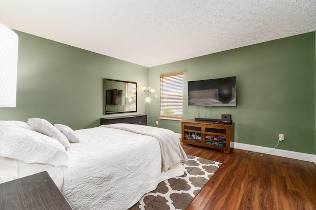 3854 Sugarbark Dr, Canal Winchester, OH 43110 - bedroom with wood finished floors, baseboards, and a textured ceiling