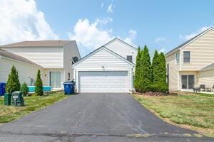 view of front of house featuring asphalt driveway and an attached garage