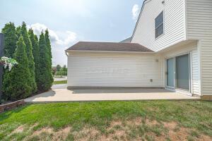 rear view of house featuring a patio and a lawn
