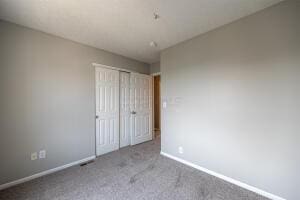 unfurnished bedroom with baseboards, carpet, and a closet