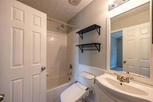 full bathroom featuring toilet, tub / shower combination, and vanity