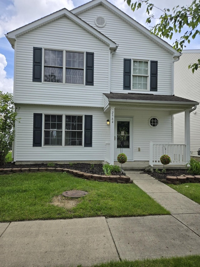 view of front facade with covered porch and a front yard