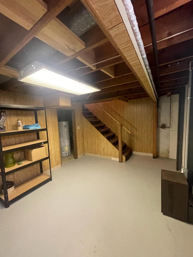 137 Tarryton Ct W Unit 24H, Columbus, OH 43228 - below grade area featuring gas water heater, wood walls, and stairway