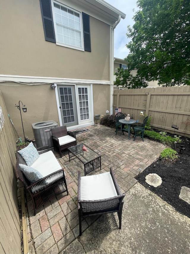 137 Tarryton Ct W Unit 24H, Columbus, OH 43228 - view of patio / terrace featuring fence, an outdoor hangout area, and central AC unit