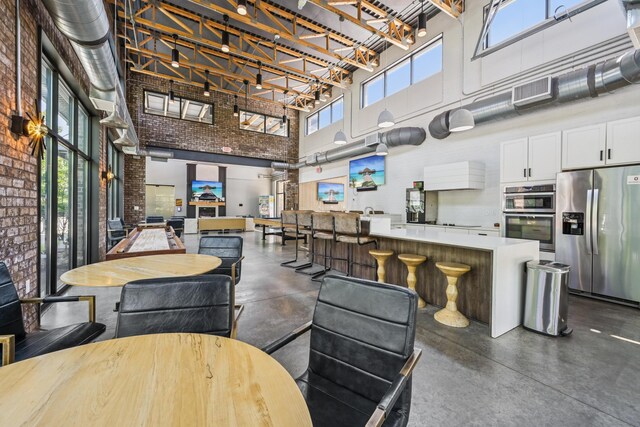 304 Cornelius St, Columbus, OH 43215 - living room featuring a towering ceiling and concrete flooring
