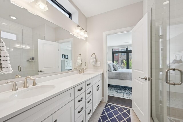 304 Cornelius St, Columbus, OH 43215 - ensuite bathroom featuring double vanity, a stall shower, and tile patterned flooring
