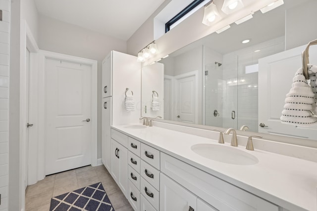 304 Cornelius St, Columbus, OH 43215 - bathroom with double vanity, a stall shower, and tile patterned floors