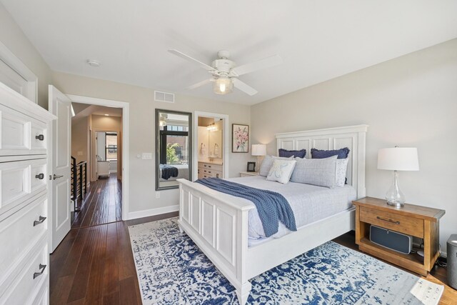 304 Cornelius St, Columbus, OH 43215 - bedroom featuring dark wood-type flooring, baseboards, ceiling fan, and ensuite bath