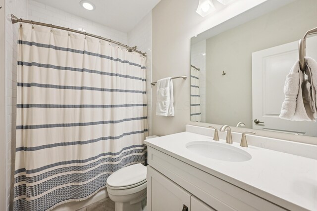 304 Cornelius St, Columbus, OH 43215 - full bathroom featuring vanity, toilet, and a shower with shower curtain