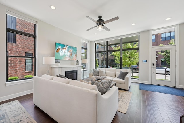 304 Cornelius St, Columbus, OH 43215 - living room featuring a tiled fireplace, ceiling fan, baseboards, dark wood-style floors, and recessed lighting