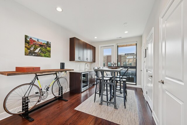 304 Cornelius St, Columbus, OH 43215 - dining room featuring wine cooler, dark wood-style flooring, baseboards, and recessed lighting