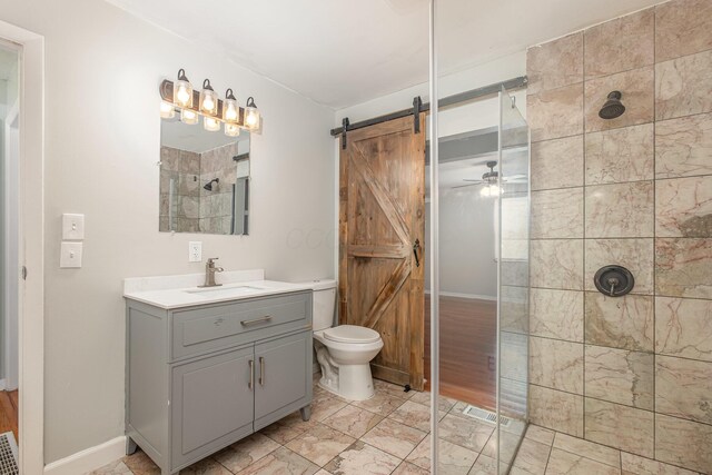 bathroom with a walk in shower, toilet, vanity, baseboards, and a ceiling fan