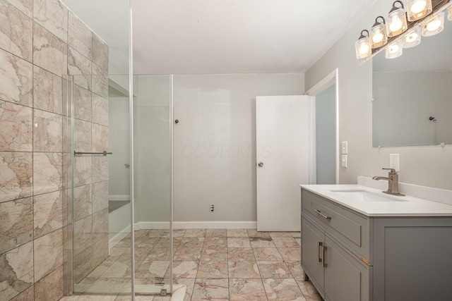bathroom with a shower stall, marble look tiles, and vanity
