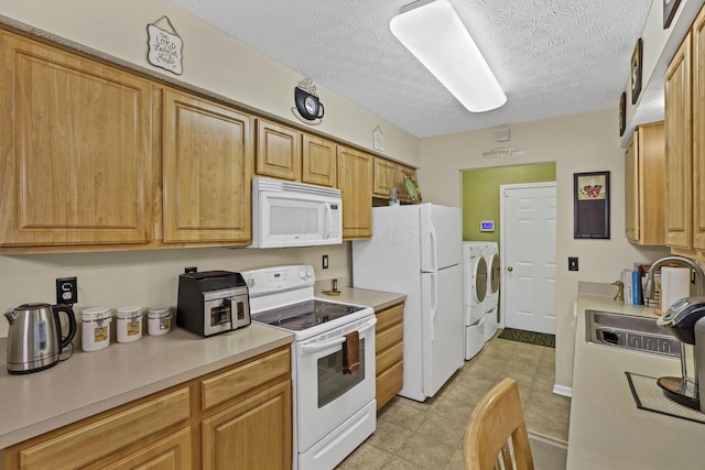 577 S Market St, Lithopolis, OH 43136 - kitchen featuring white appliances, washing machine and dryer, a sink, light countertops, and light tile patterned floors