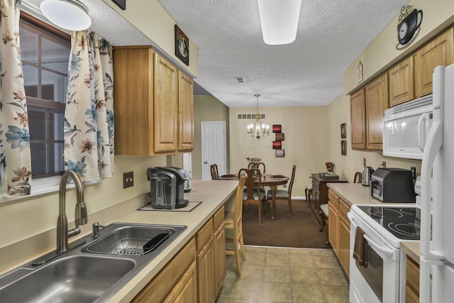 577 S Market St, Lithopolis, OH 43136 - kitchen featuring a sink, white appliances, a chandelier, light countertops, and pendant lighting