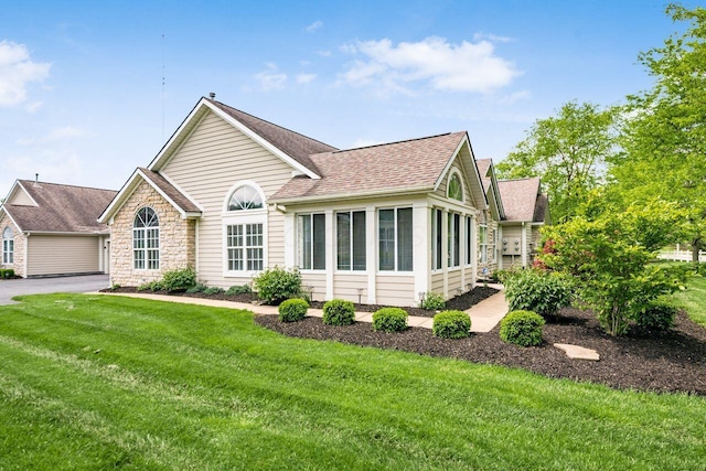 6323 Pinehurst Pointe, Westerville, OH 43082 - ranch-style home featuring a shingled roof, a front lawn, and stone siding
