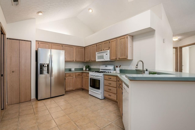 6323 Pinehurst Pointe, Westerville, OH 43082 - kitchen with white appliances, lofted ceiling, light tile patterned floors, a peninsula, and a sink