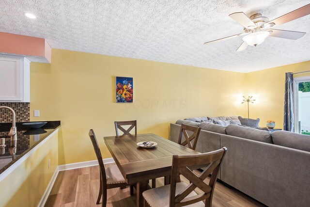 5210 Novelty Ave Unit 73D, Canal Winchester, OH 43110 - dining space featuring light wood-style flooring, baseboards, and ceiling fan
