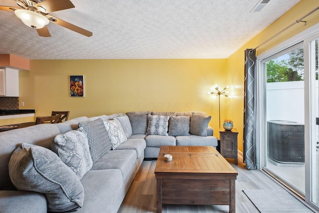 5210 Novelty Ave Unit 73D, Canal Winchester, OH 43110 - living area featuring light wood finished floors, a ceiling fan, and a textured ceiling