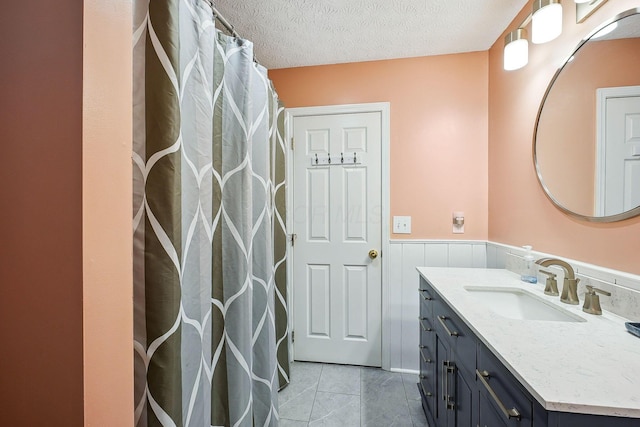 5210 Novelty Ave Unit 73D, Canal Winchester, OH 43110 - full bathroom featuring vanity, a wainscoted wall, and a textured ceiling