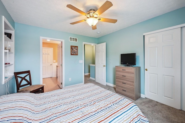 5210 Novelty Ave Unit 73D, Canal Winchester, OH 43110 - bedroom featuring light colored carpet, baseboards, ensuite bath, ceiling fan, and a textured ceiling