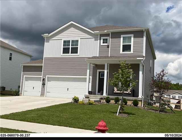 view of front of property with a porch, driveway, a front lawn, and an attached garage