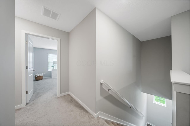 385 Kells Ct E, Newark, OH 43055 - hall with an upstairs landing, light carpet, and baseboards