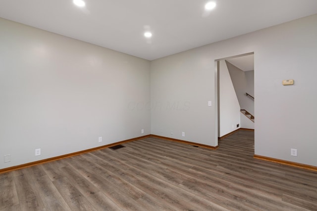 692 Millsboro Rd, Mansfield, OH 44903 - unfurnished room with baseboards, recessed lighting, wood finished floors, and stairway