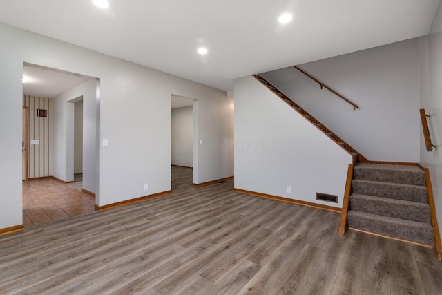 692 Millsboro Rd, Mansfield, OH 44903 - unfurnished living room featuring wood finished floors, stairway, recessed lighting, and baseboards