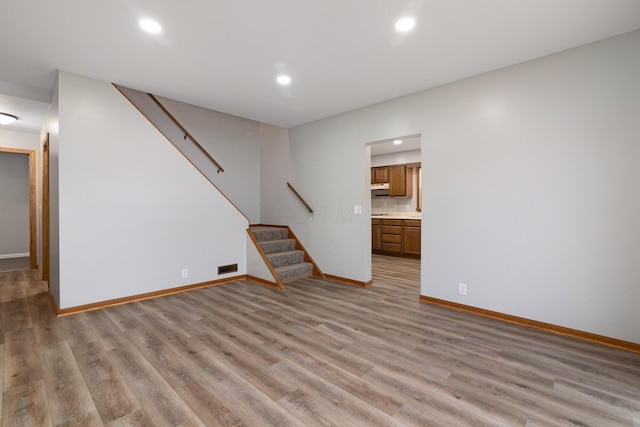 692 Millsboro Rd, Mansfield, OH 44903 - unfurnished living room with baseboards, light wood-style floors, stairs, and recessed lighting