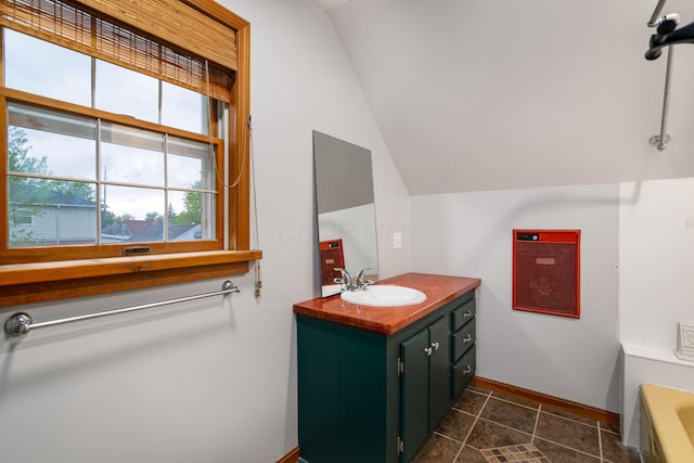 692 Millsboro Rd, Mansfield, OH 44903 - full bathroom with baseboards, vanity, a bathtub, and lofted ceiling
